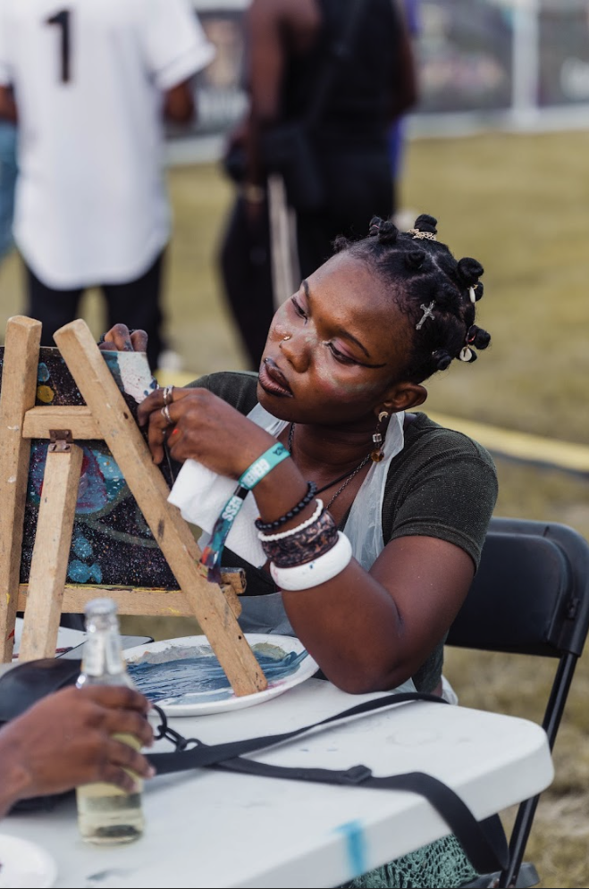 Girl painting at Accravaganza Event 